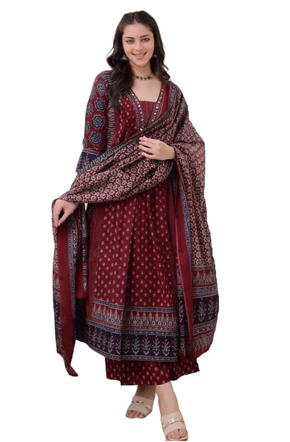 Woman wearing a maroon printed ethnic kurta with a matching patterned dupatta, posing against a plain background.