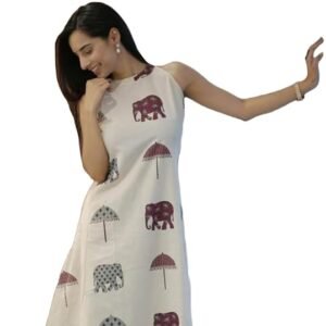 Woman wearing a white sleeveless dress with elephant and umbrella prints, posing against a plain background.