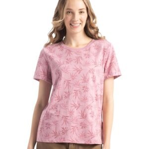 Woman wearing a pink printed t-shirt with short sleeves, styled with brown pants against a plain background.