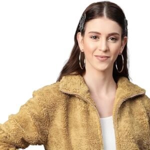 Woman wearing a beige teddy fleece jacket with hoop earrings and casual styling